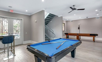 clubhouse with billiards table and shuffleboard table in the background